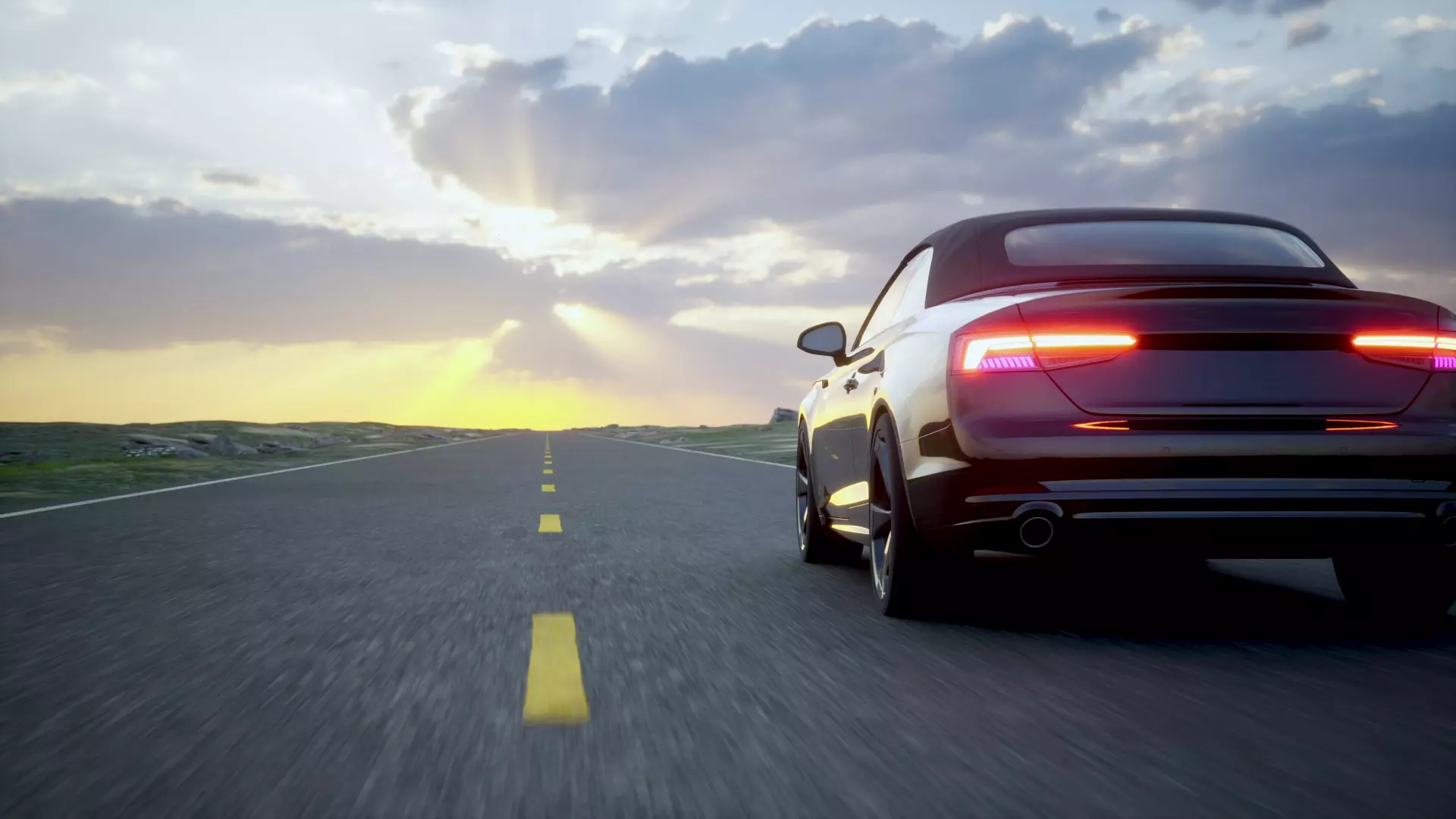 Car on an open road at sunset
