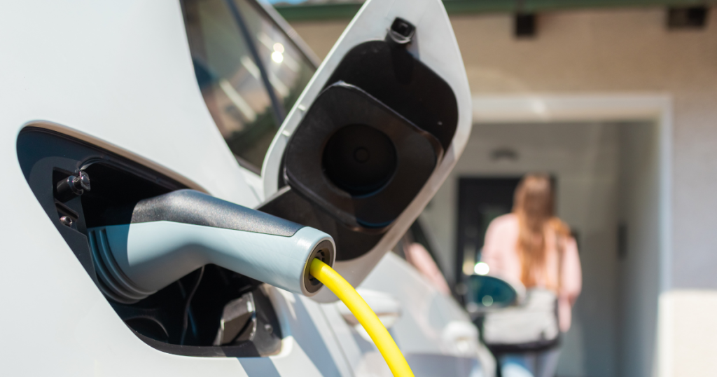 Used Tesla battery health check in Canada showing home charging habits and EV charging cable connected to the vehicle.