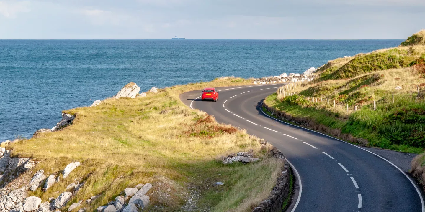 Vehicle driving along a coastal road