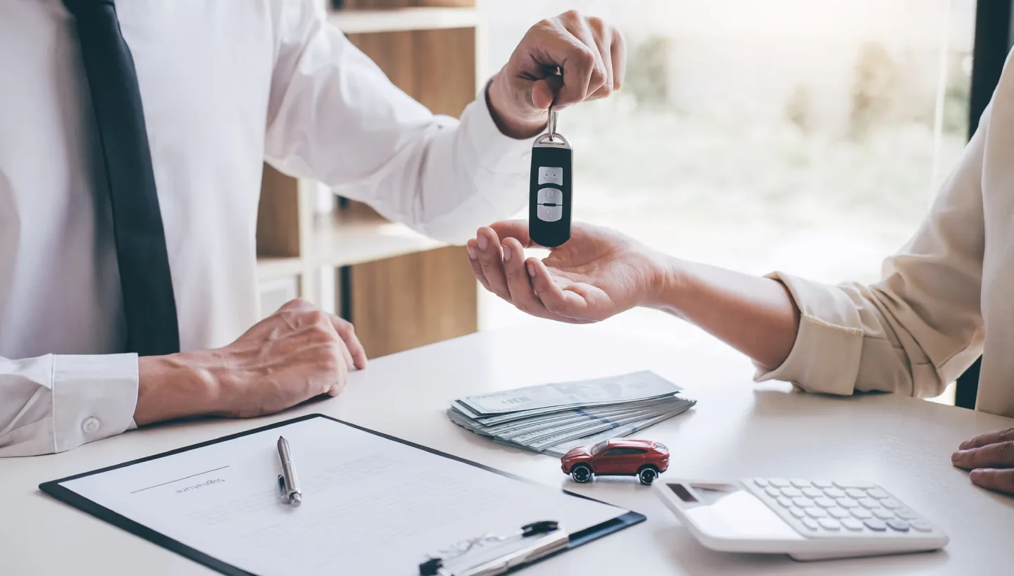 Car keys handed over across a desk