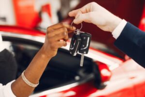 Stylish black woman in a car salon