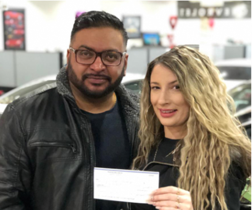happy customer receiving check from referral program