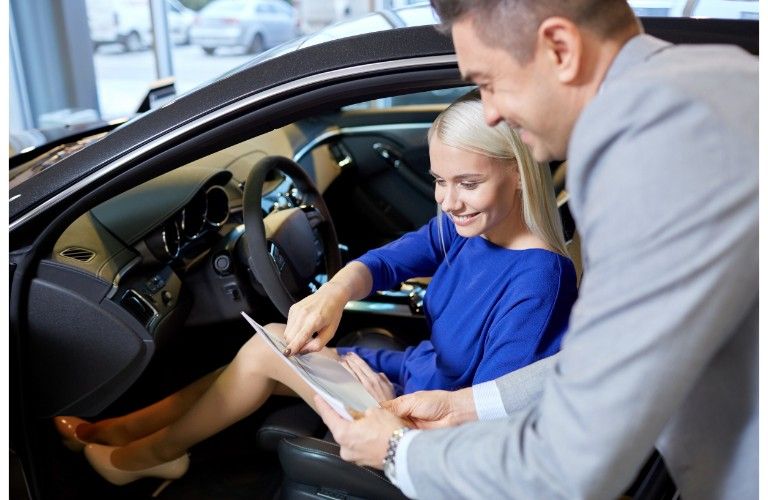 lady in car looking at paperwork
