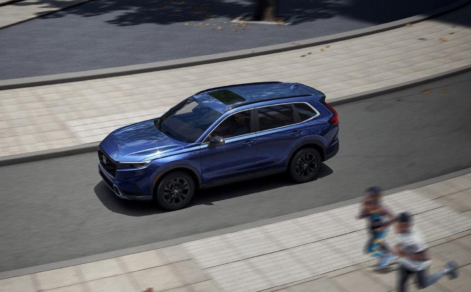 blue 2023 honda cr-v driving