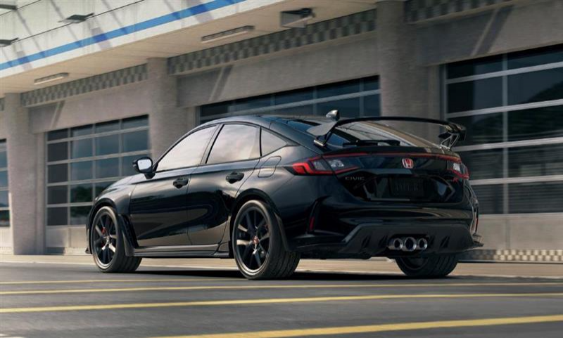 Black Honda Civic Type R parked in front of building