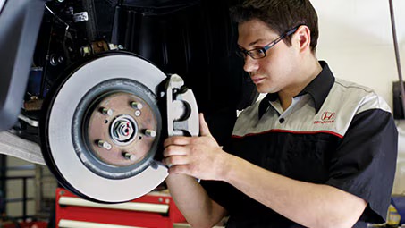 Technician changing brake fluid