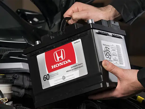 Technician changing Honda battery
