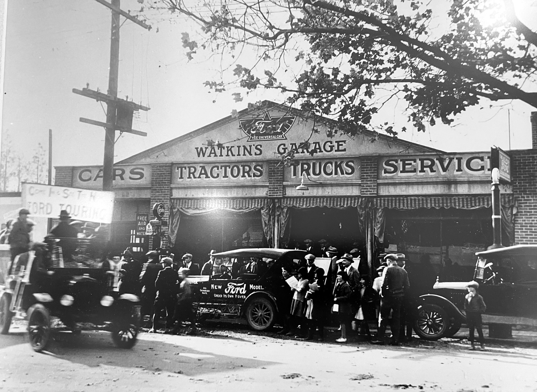 Watkins Garage in Vernon BC in its early years, sign reading Cars Tractors Trucks Service