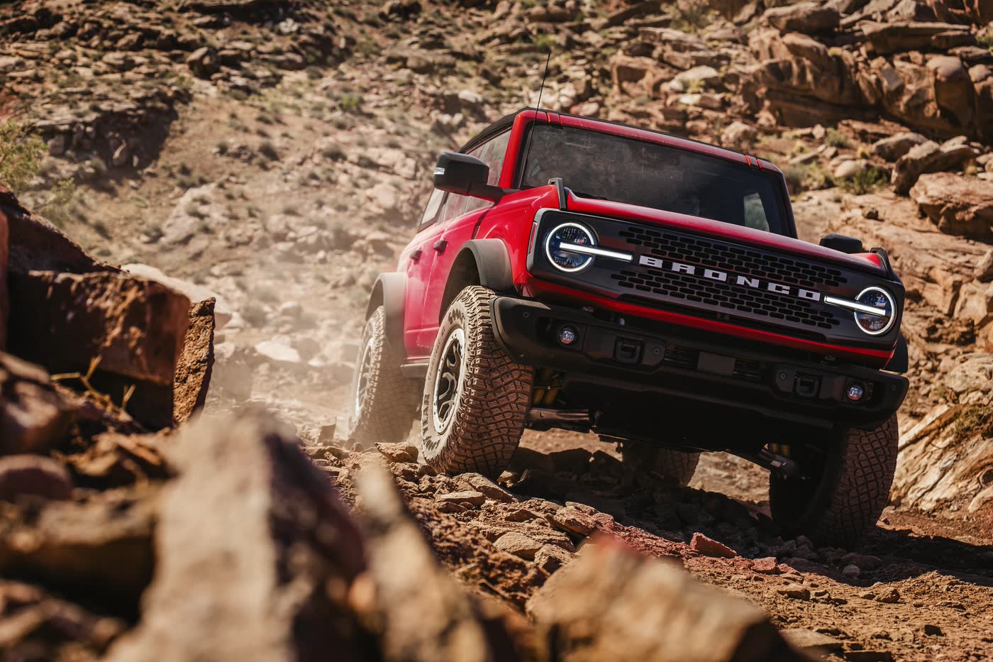 Red 2026 Ford Bronco Badlands climbing a rocky off-road trail