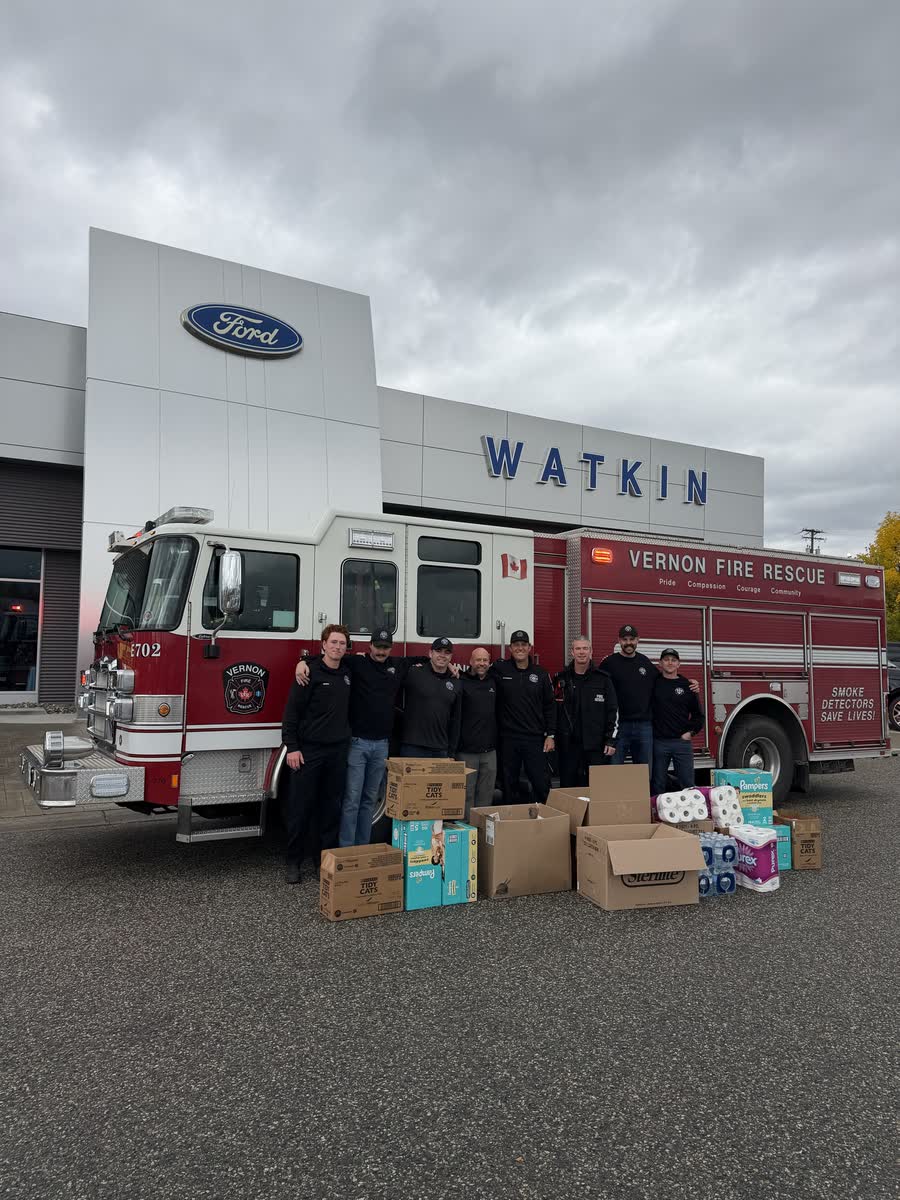 Vernon Fire Rescue crew with their fire truck and donated food outside Watkin Motors Ford