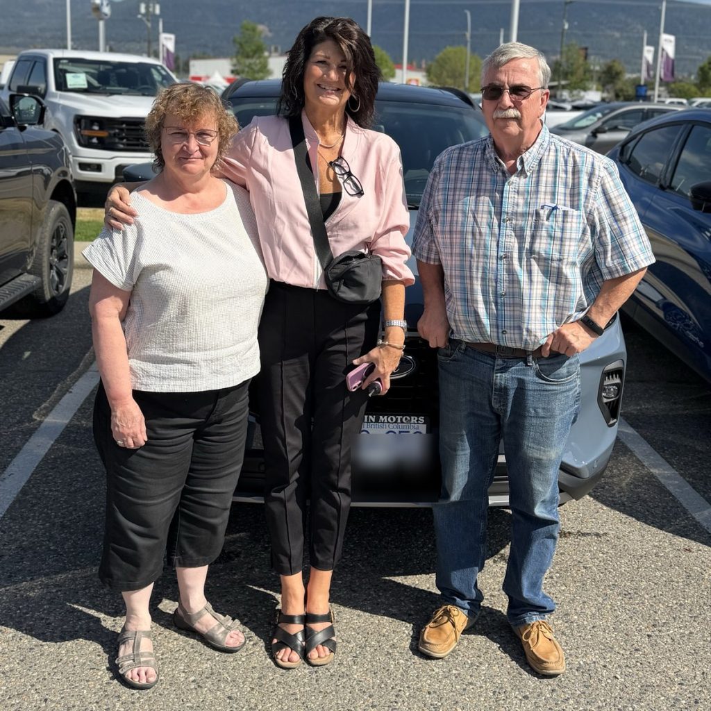 Smiling customers with their new Ford at Watkin Motors Ford