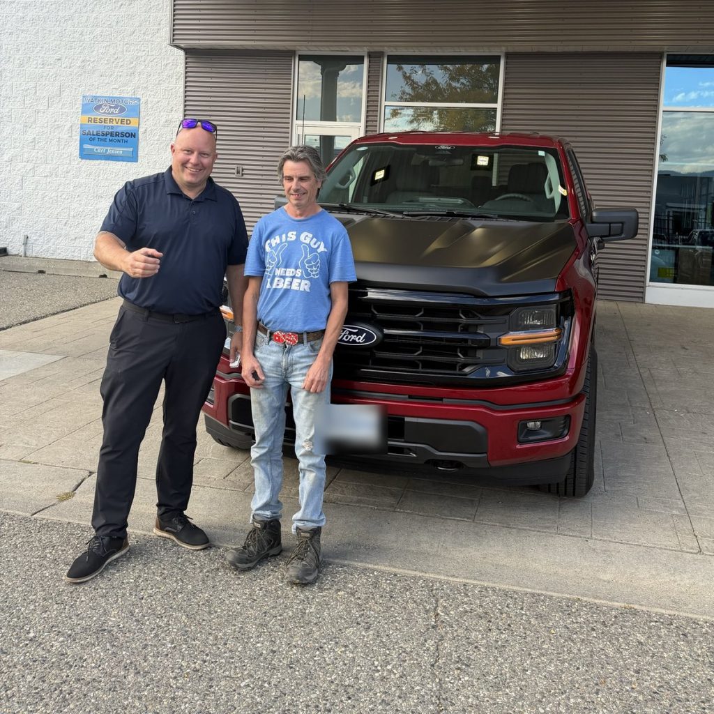 New Ford pickup owner with his salesperson at Watkin Motors