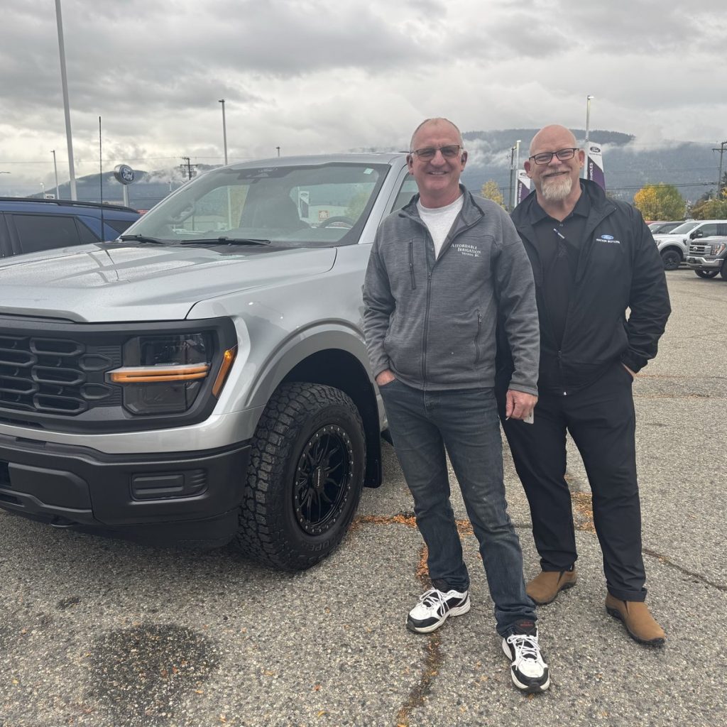 New Ford pickup owner with his salesperson in Vernon