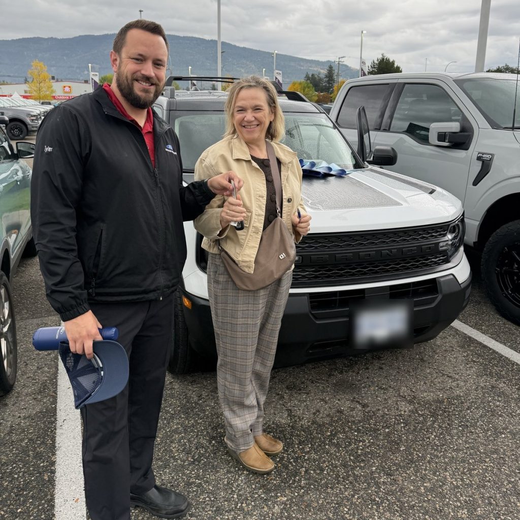 Customer receiving the keys to her new Ford at Watkin Motors in Vernon