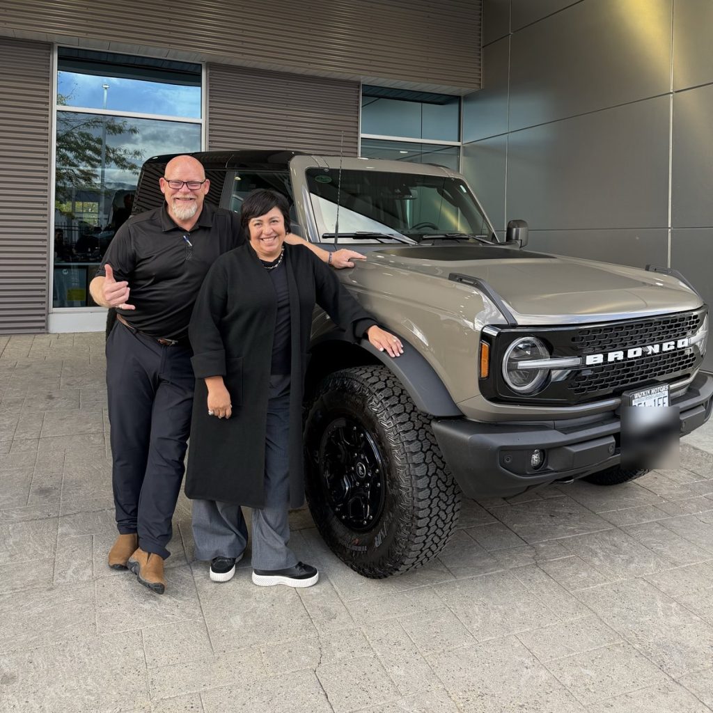 New Ford Bronco owner with her salesperson at Watkin Motors