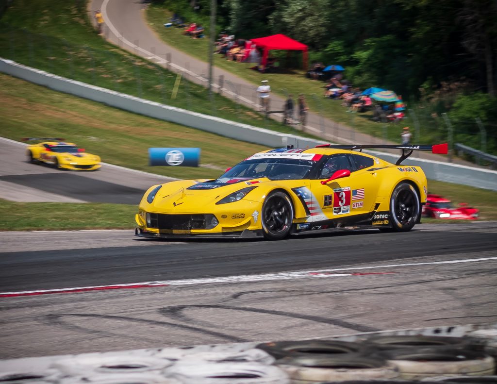 yellow corvette racecar on racetrack