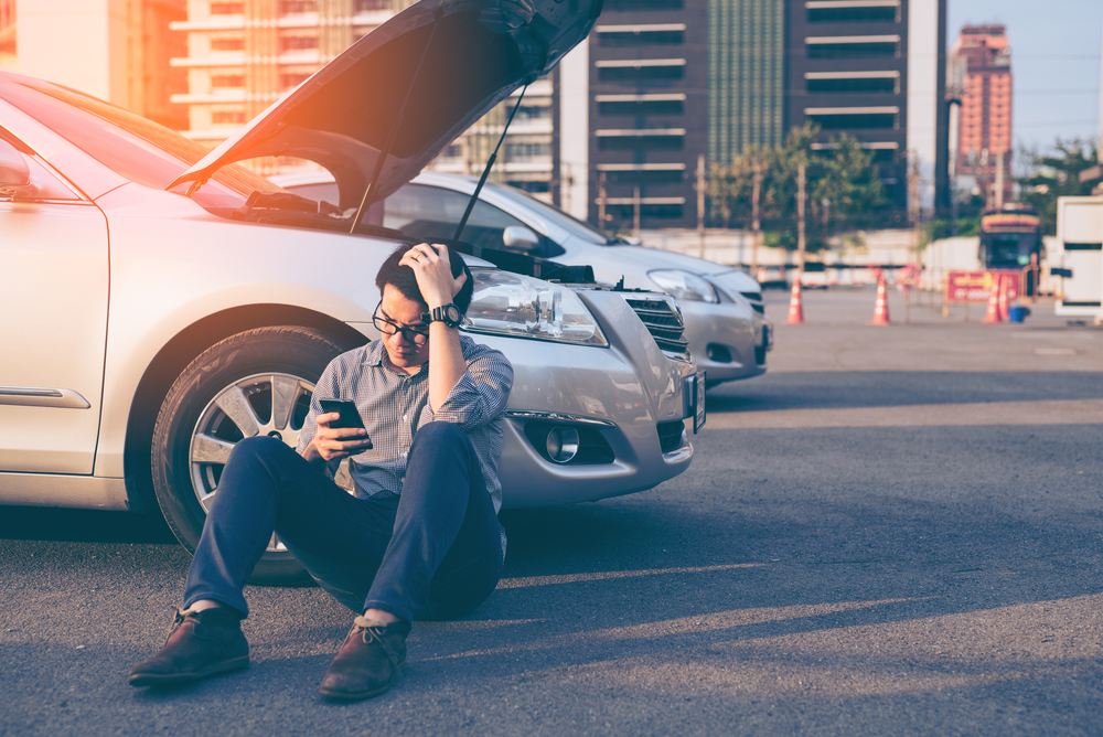 man making a phone call after car accident