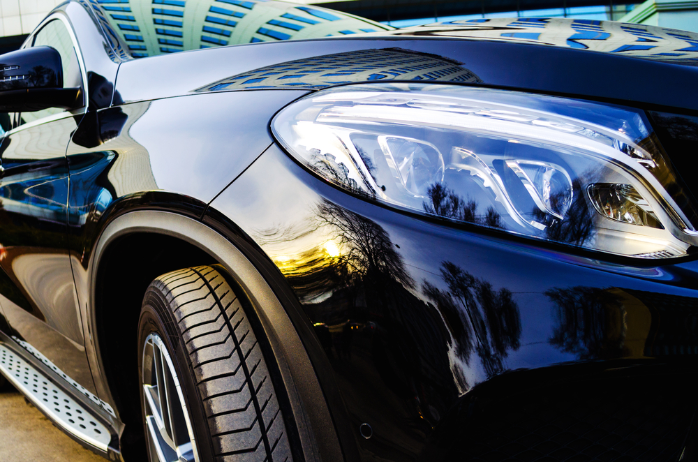 Well Maintained dark blue rental car headlight.