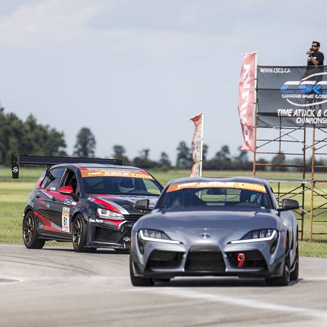 Toyota Supra racing at Toronto motorsports park in the summer.