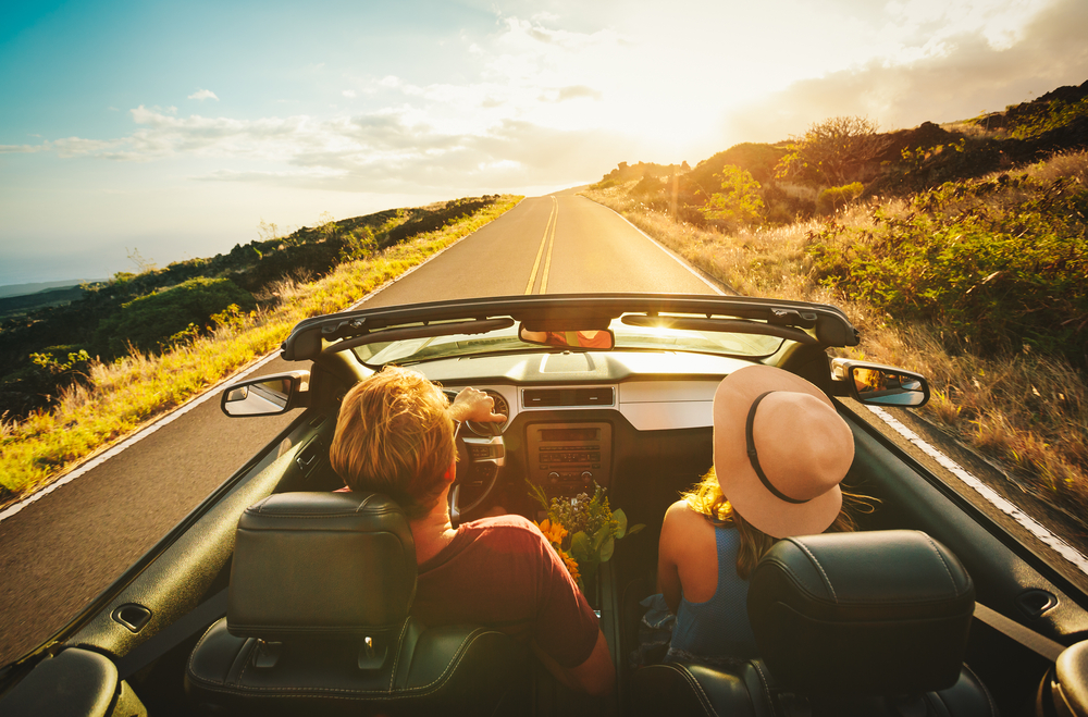 happy couple driving off into the sunset