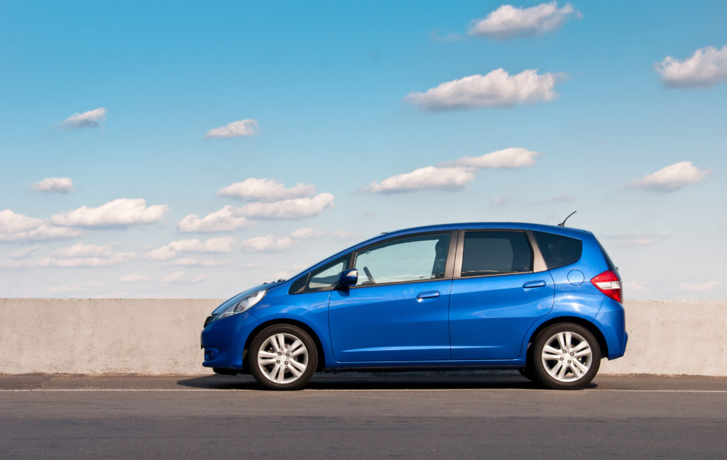 blue car parked on side of road