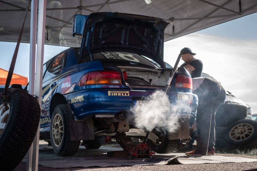 blue rally car on jack stand