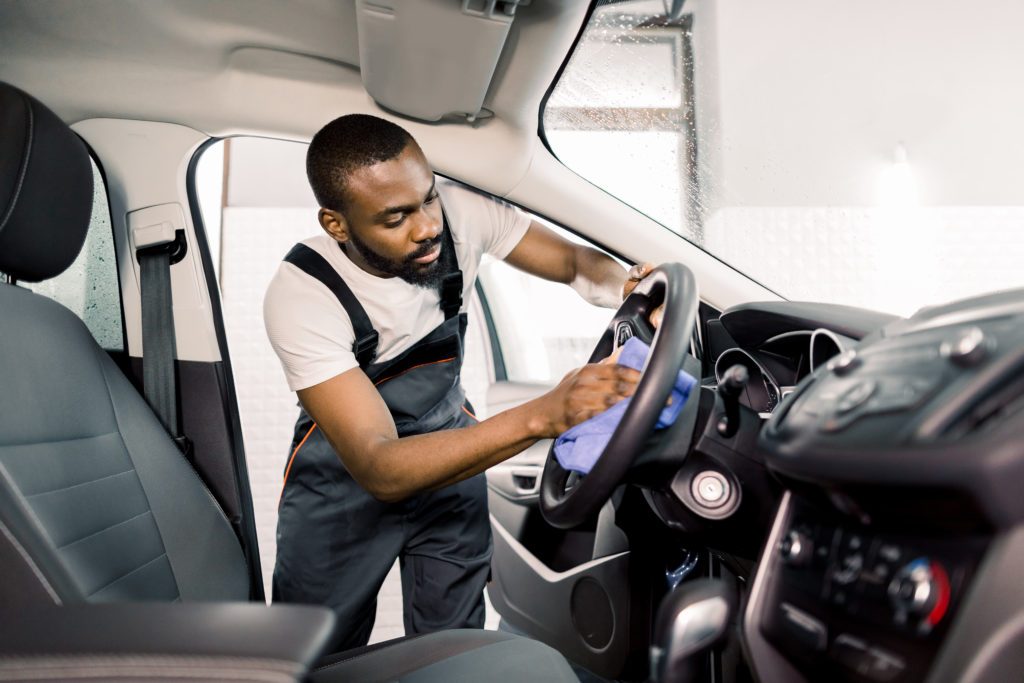 man cleaning car by hand